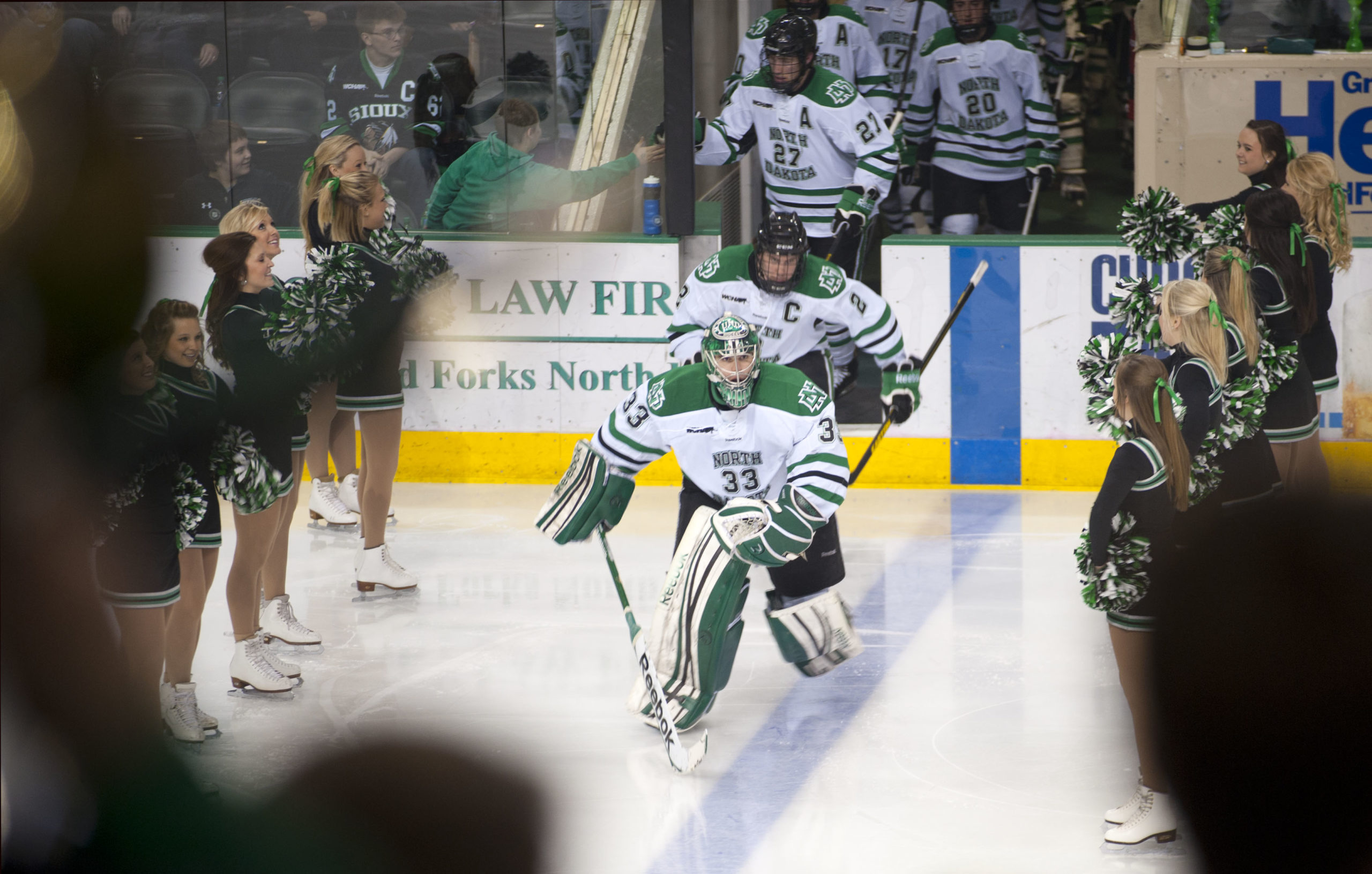 Members of the UND mens hockey team skate out onto the ice at a game in Grand Forks