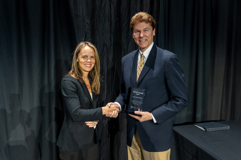 Meghan Compton presents the 2023 Klaus Thiessen Impact Award to Dave Molmen at the 2023 EDC Annual Meeting.