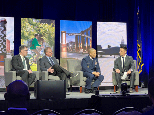 UND President Andrew Armacost, Altru CEO Todd Forkel, and GFAFB Colonel Rivera sit on the stage being interviewed by Mayor Brandon Bochenski at the Grand Forks State of the City Address on May 10, 2023 at the Alerus Center.