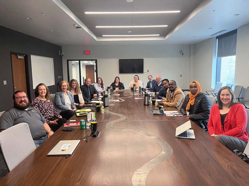 A group of people sit around the Boardroom table in The HIVE in Downtown Grand Forks. All present participate in the workforce pipeline programming for the Grand Forks region.