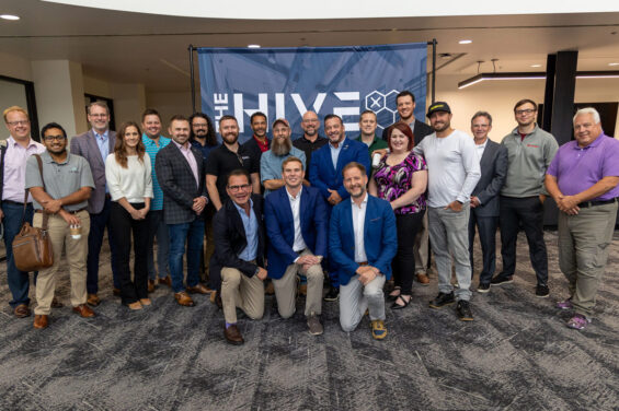 A group of entrepreneurs stand together around O'Leary Ventures CEO, Paul Palandjian, Principal of Investments, Matt Scalise, and Advisor, David Haukkas at The HIVE a UAS Tech Accelerator in Grand Forks, North Dakota.