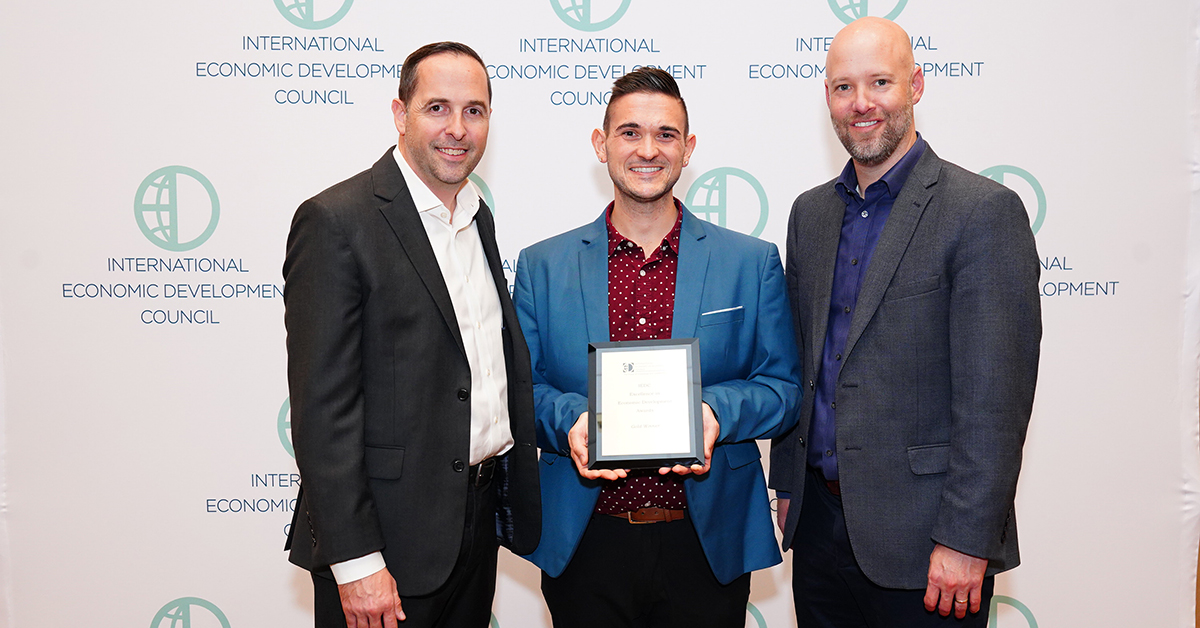 IEDC leadership present the Gold Award to the Grand Forks Region EDC at the annual conference in Dallas, TX. From left to right, IEDC President & CEO, Nathan Ohle, Grand Forks Region EDC Marketing & Communications Manager, Mark Maliskey, and IEDC Chair, Jonas Peterson.