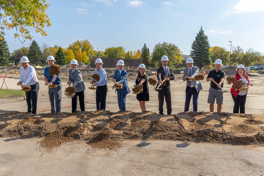 A group of community leaders hold shovels at the Career Impact Academy Groundbreaking ceremony.