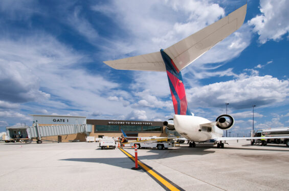 A Delta airplane is docked at the Grand Forks international airport.