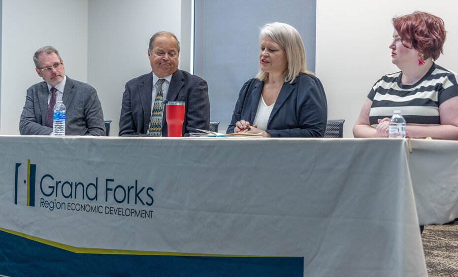 From left to right, Keith Lund, EDC President & CEO; Barry Wilfhart, Chamber of GF/EGF President & CEO; Dawn Mandt, Executive Director of Red River Regional Council; Becca Cruger, EDC Director of Workforce Development sit at a table with an EDC table cloth.