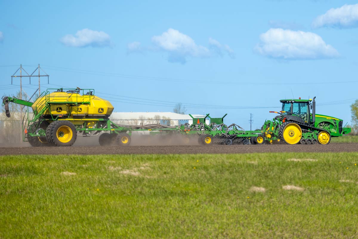 a tractor is planing a field in the spring