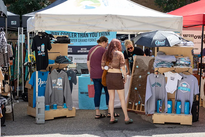 The Greater Grand Forks: Way Cooler Than You Think!'s booth at the Downtown Street Fair in August 2024.