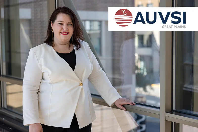Becca Cruger headshot with the AUVSI logo in the top right corner.