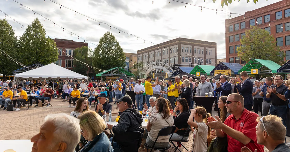 A crowd gathers in Grand Forks town square listening to speakers at the Agristo Community Welcome event on Monday, August 25th.