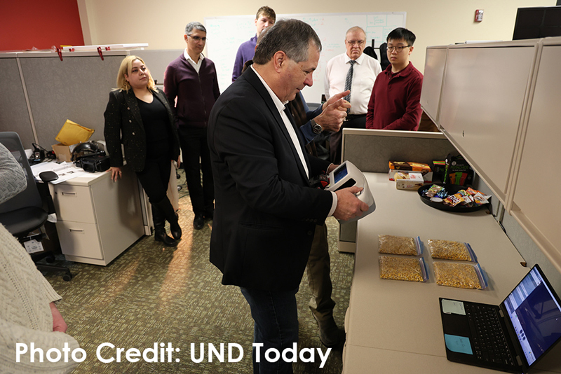 North Dakota Agriculture Commissioner Doug Goehring tests a contamination and sanitation inspection system at the UND Center For Innovation. Photo by Adam Kurtz/UND Today.