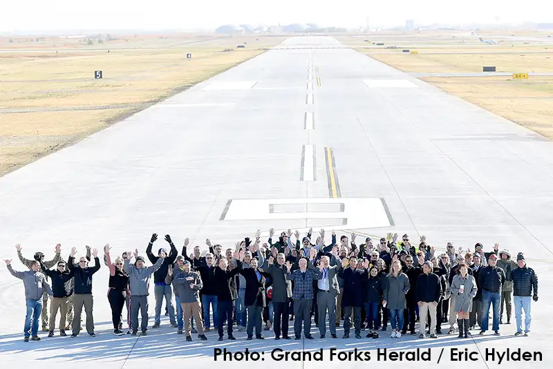 Local, state and federal officials gather with community members at the new crosswind runway at GFK Wednesday, Oct. 16, 2024.Eric Hylden/Grand Forks Herald