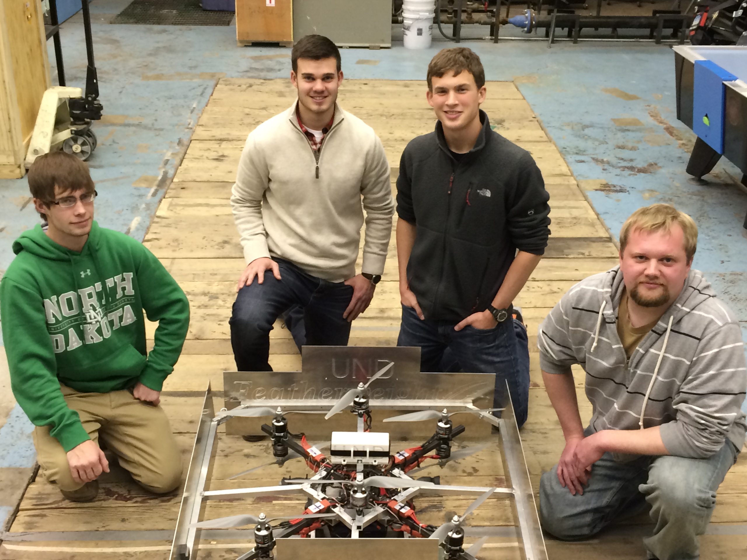 four college students working with a drone