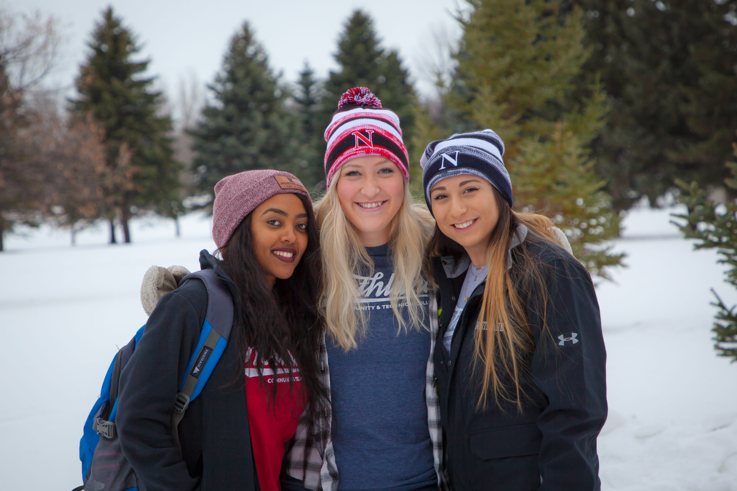 Three female students of Northland Community and Technical College pose in Grand Forks