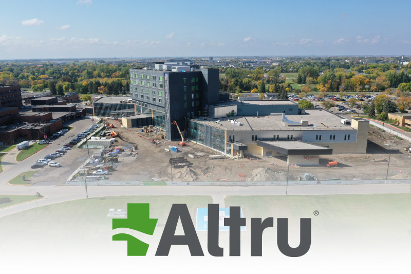 A drone shot of the new Altru Health Hospital building with the logo at the bottom of the photo.