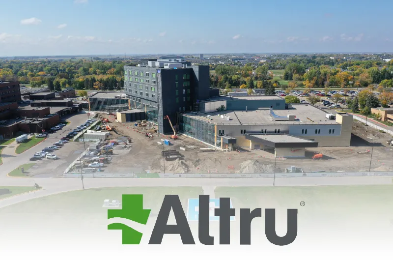 A drone shot of the new Altru Health Hospital building with the logo at the bottom of the photo.