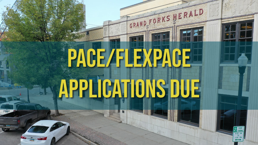 A photo of the entrance of the Grand Forks Region EDC office with the Grand Forks Herald lettering at the top of the building and the words, "PACE/FLEXPACE APPLICATIONS DUE."