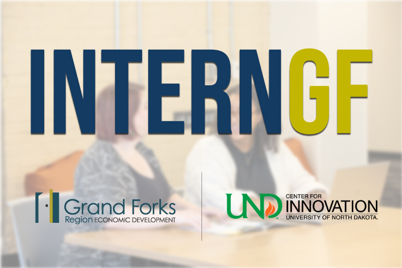 An employer and an intern sit together at a table with the InternGF logo, Grand Forks Region EDC logo, and the UND Center For Innovation logo over them.