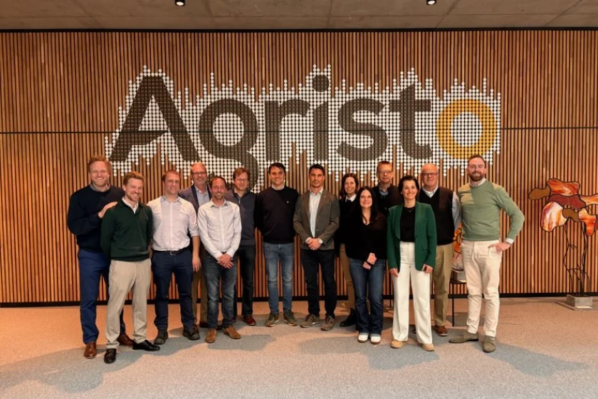 A team of leaders from Agristo in the Netherlands with leaders from the City of Grand Forks in front of the Agristo sign at the factory.